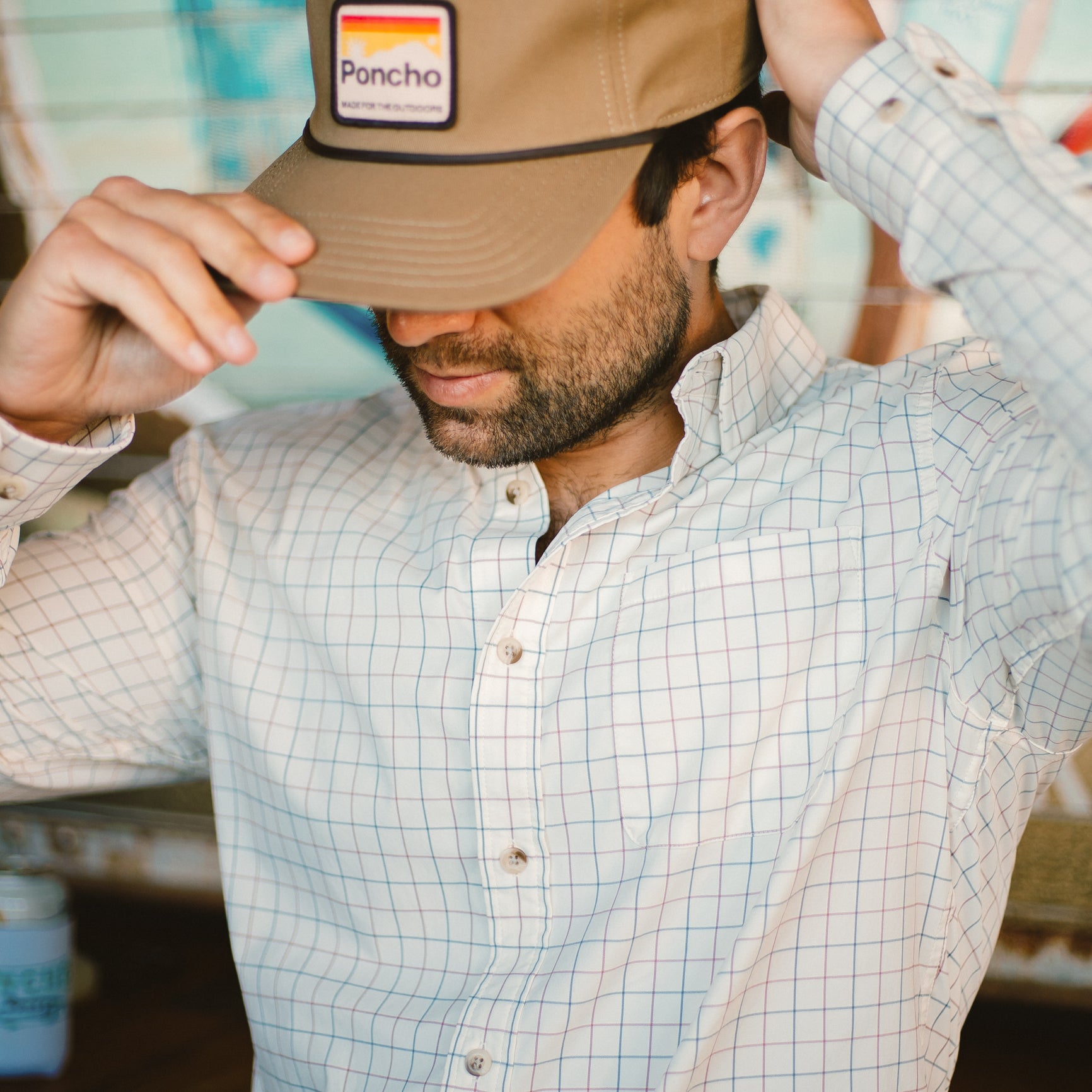 Close up of man wearing blue and red plaid button down shirt