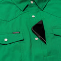 closeup of phone going into green shirt pocket