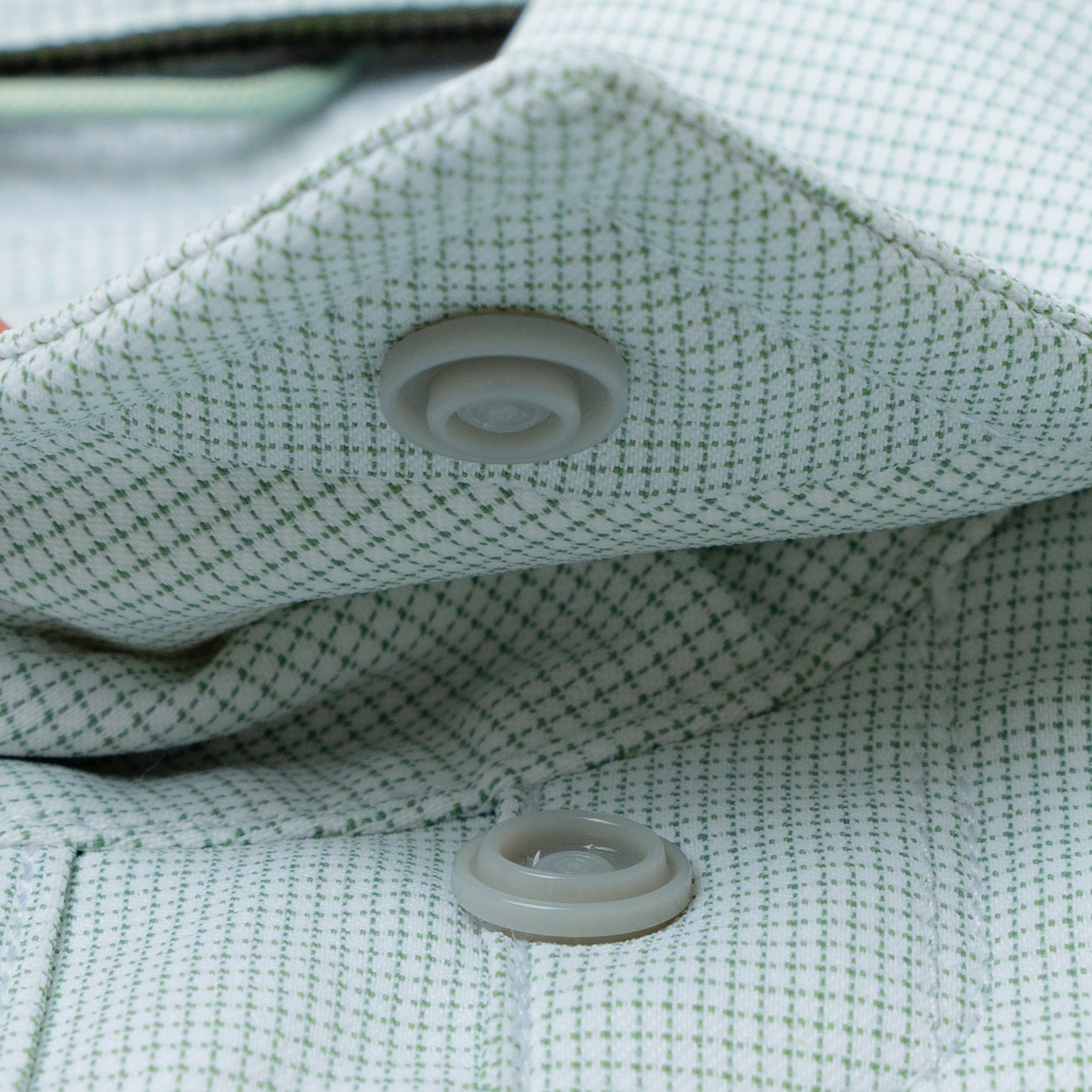 close up photo of snap collar on green micro grid shirt