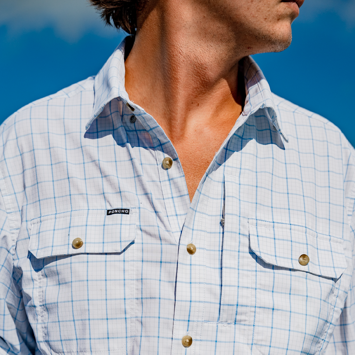 close up of man wearing a white long sleeve fishing fishing shirt