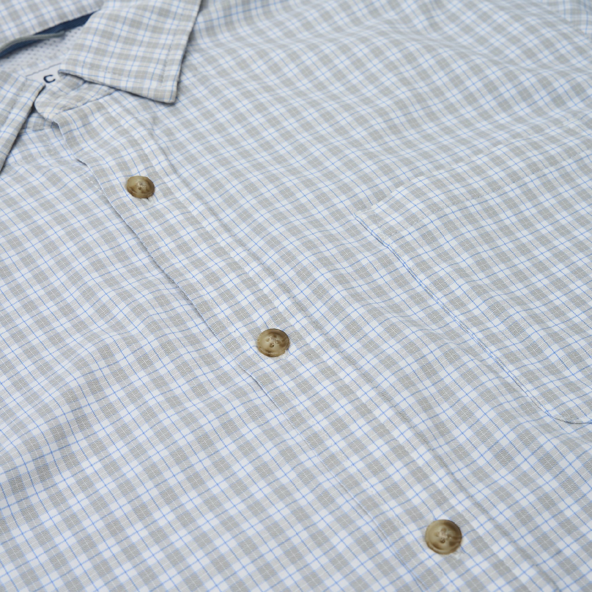 close up of grey plaid button up shirt