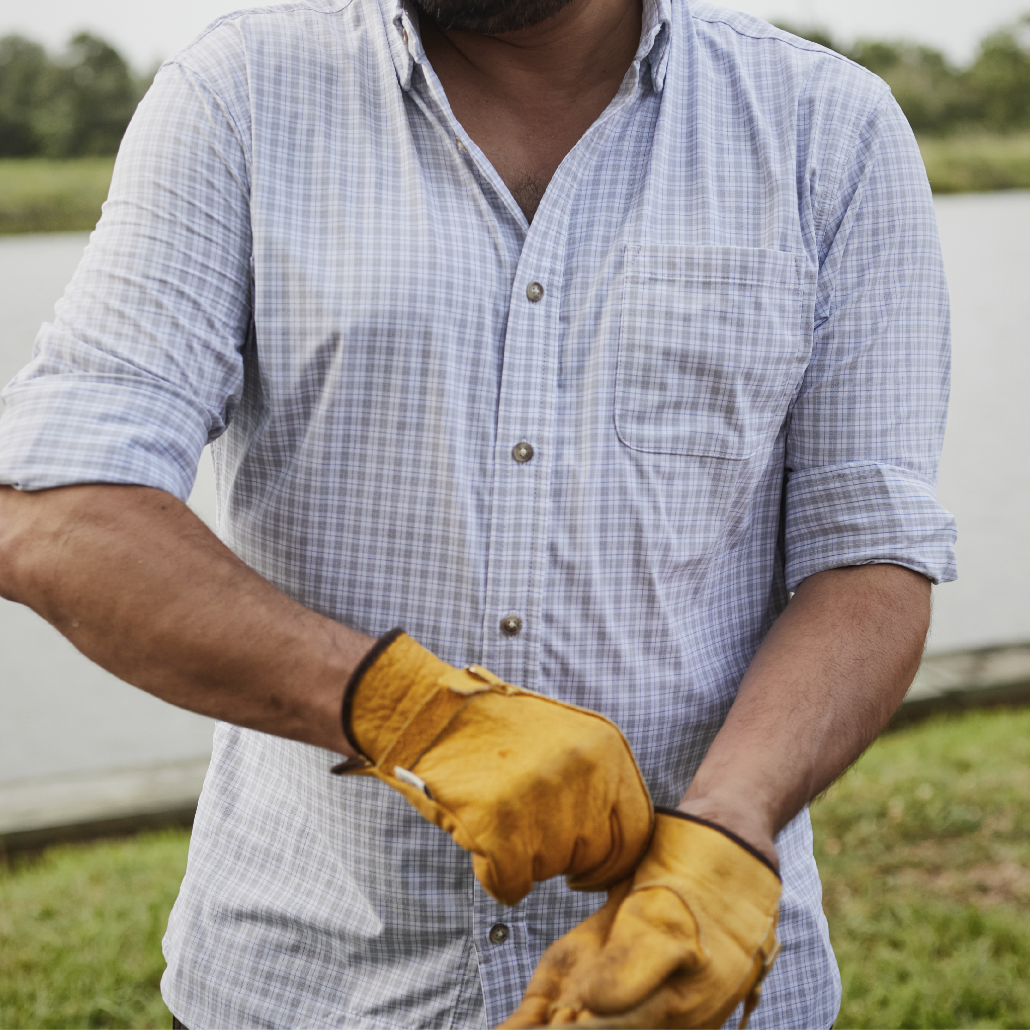 man working in grey plaid long sleeve