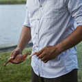 man eating crab in grey plaid long sleeve