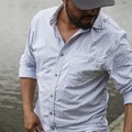 man at lake in blue plaid long sleeve