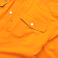 Photo of pocket on bright orange western shirt