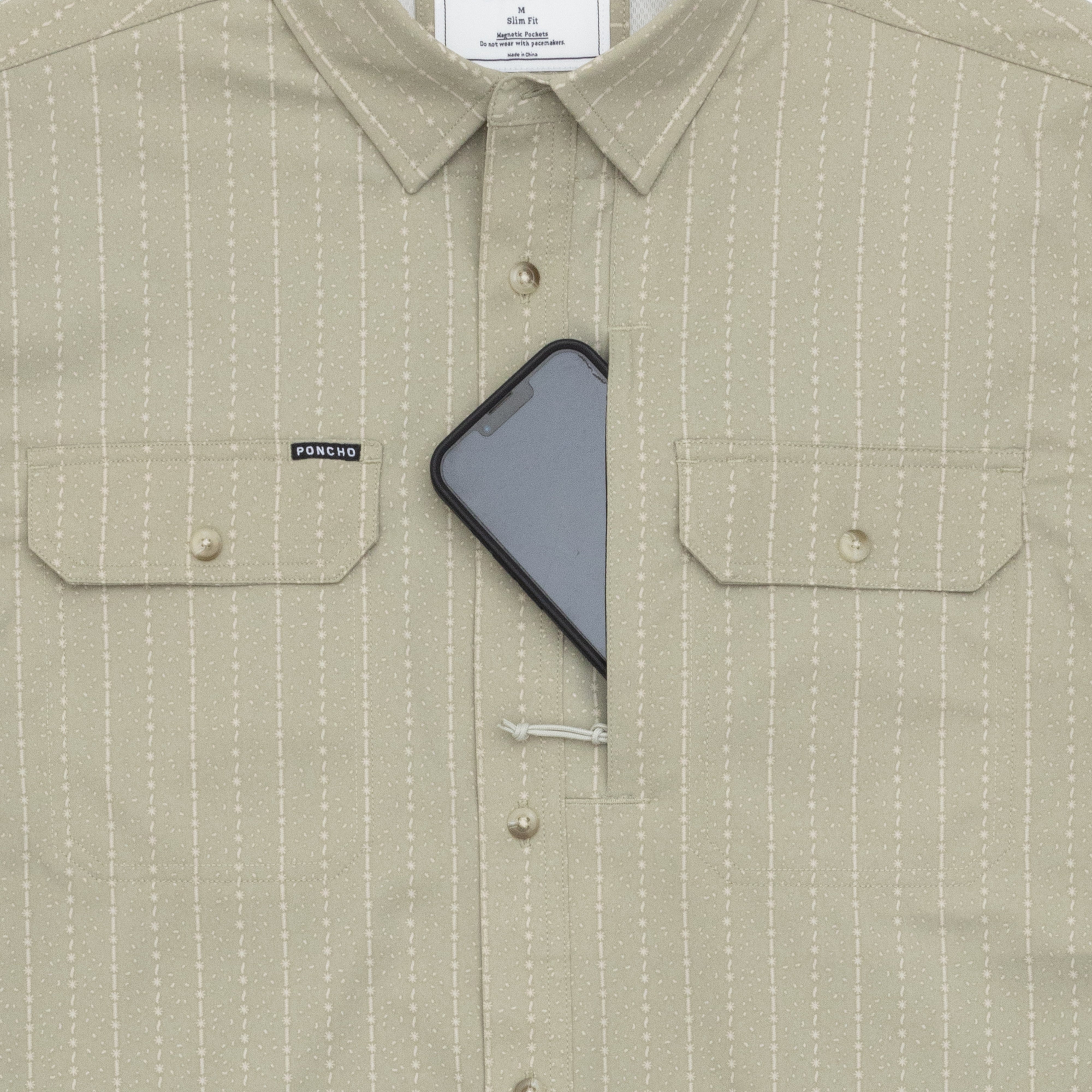 phone in chest pocket of green and stripe shirt