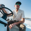 Photo of man driving a boat wearing short sleeve