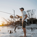 man wearing green and white plaid button down while fishing