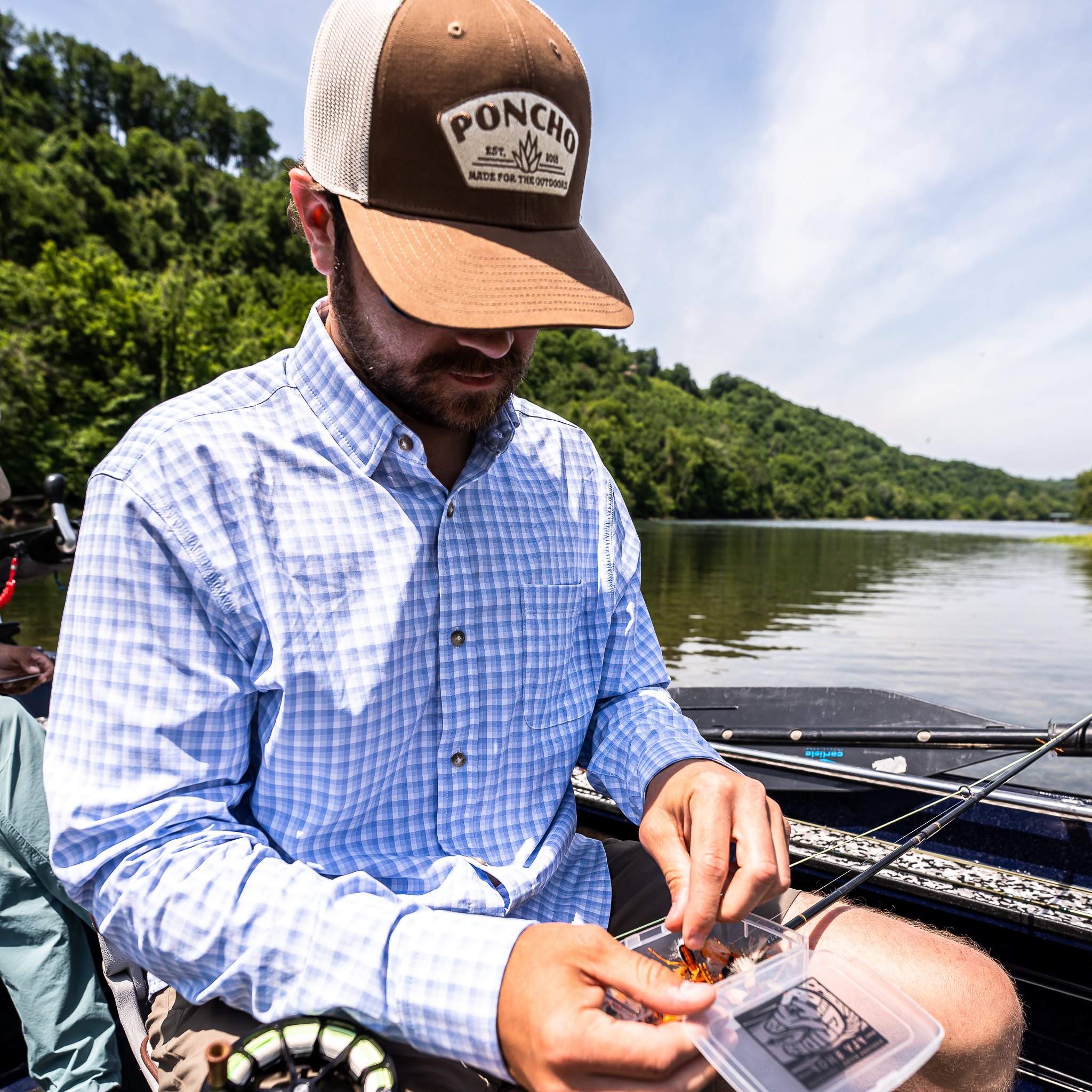 man fishing in blue plaid long sleeve