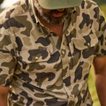 Close up photo of button down camo shirt