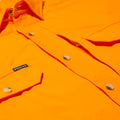 close up photo of bright orange button up shirt