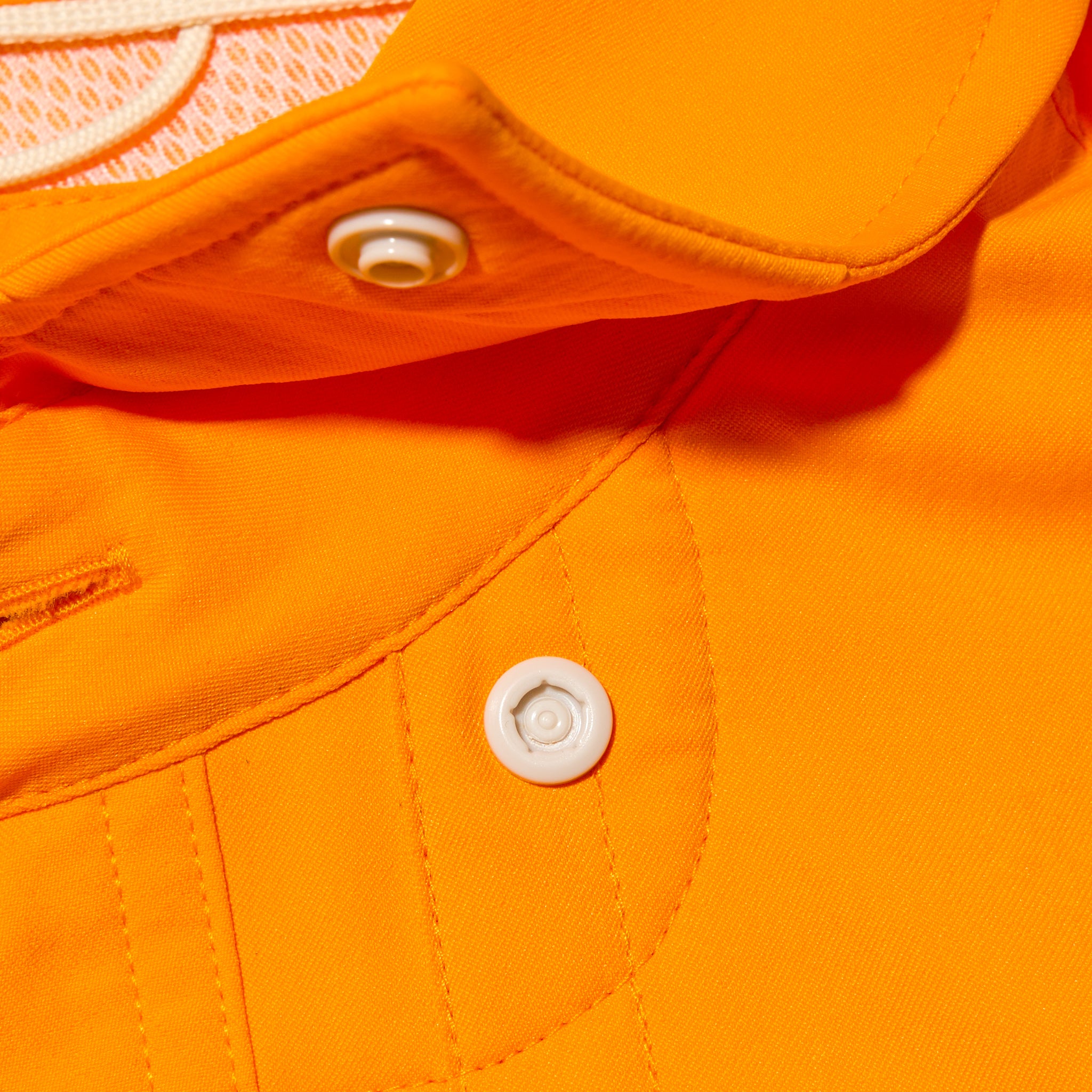 close up of snap collar on bright orange shirt