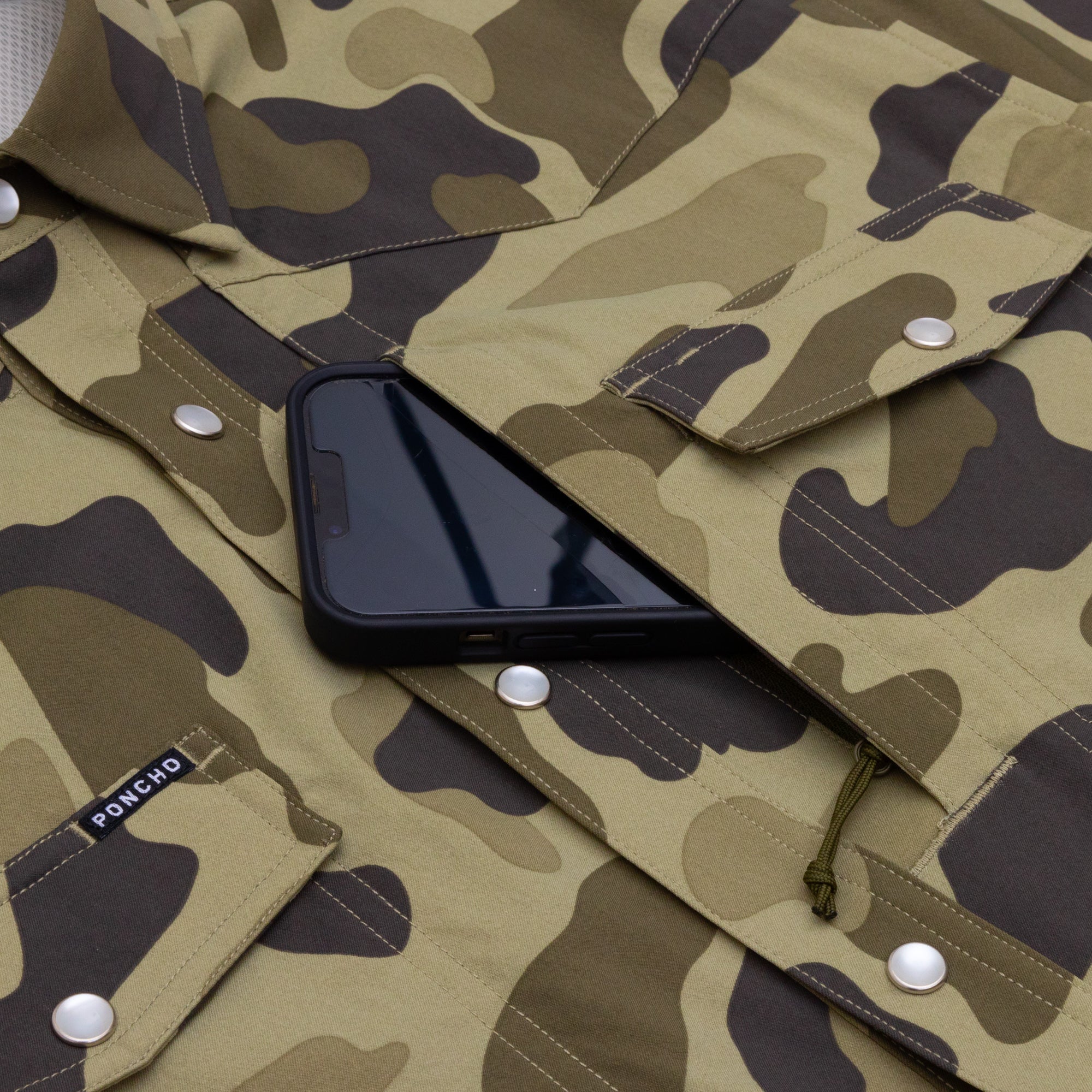 Phone in pocket of pearl snap camo shirt