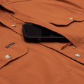 close up photo of phone chest zipper pocket on burnt orange shirt