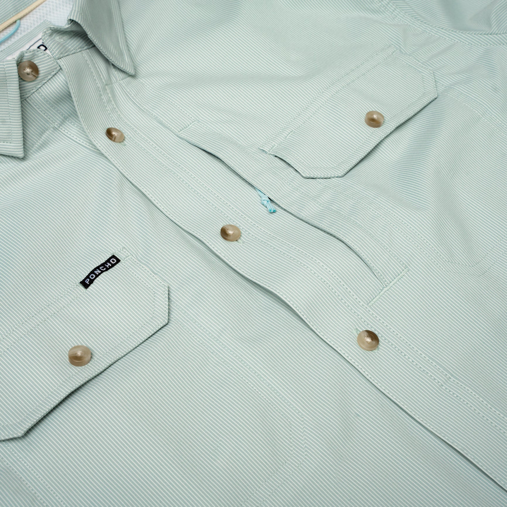 Flat lay photo of green micro stripe button up fishing shirt