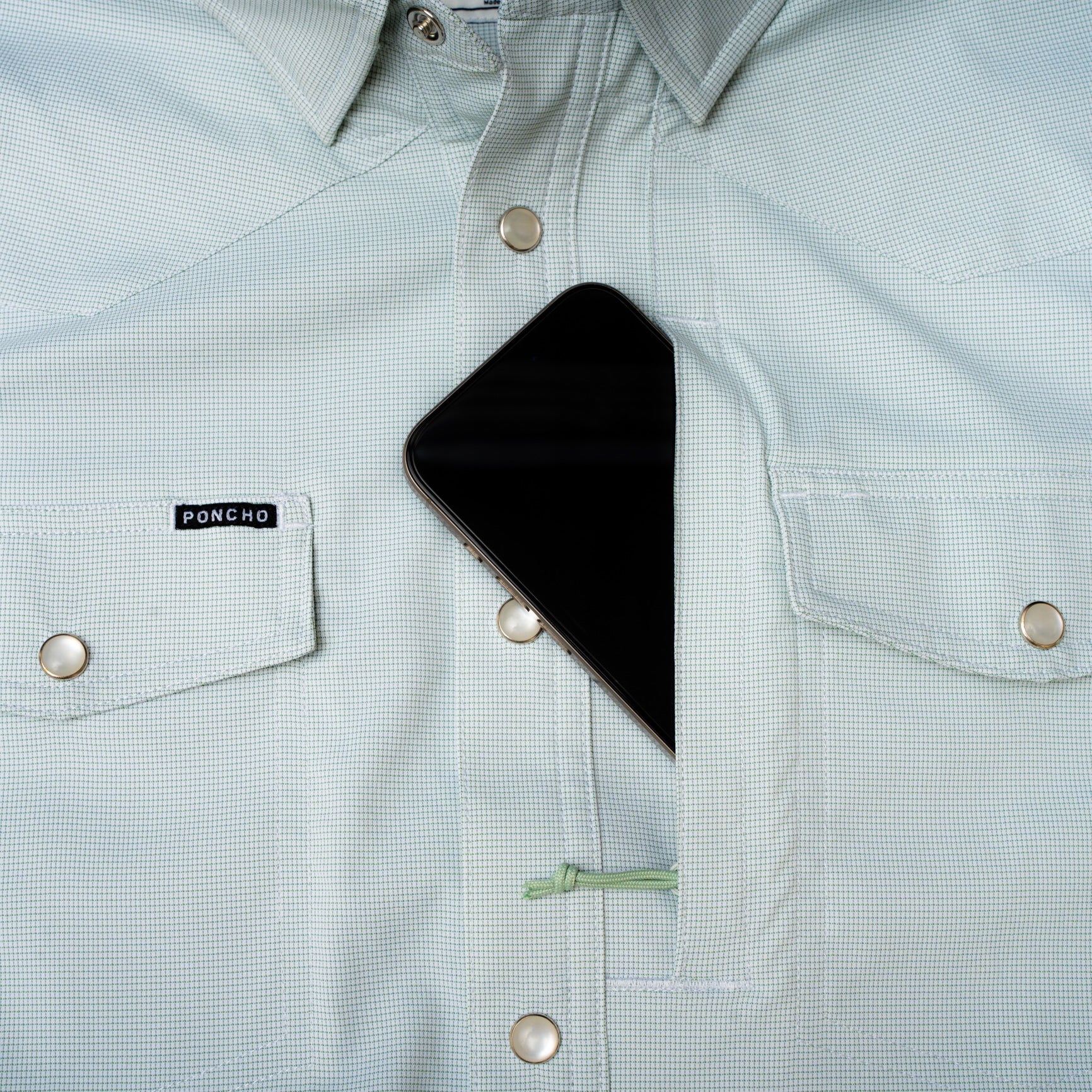 phone in chest pocket of micro grid green shirt with pearl snaps