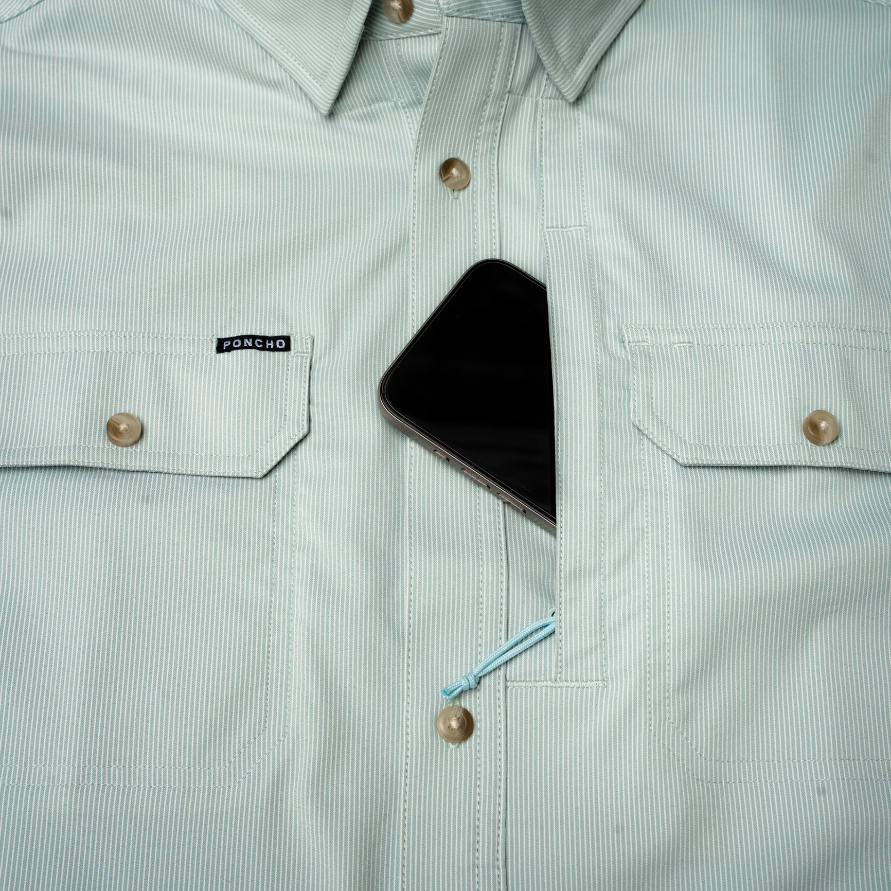 phone in hidden chest pocket of short sleeve fishing shirt