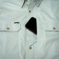 phone in hidden chest pocket of short sleeve fishing shirt