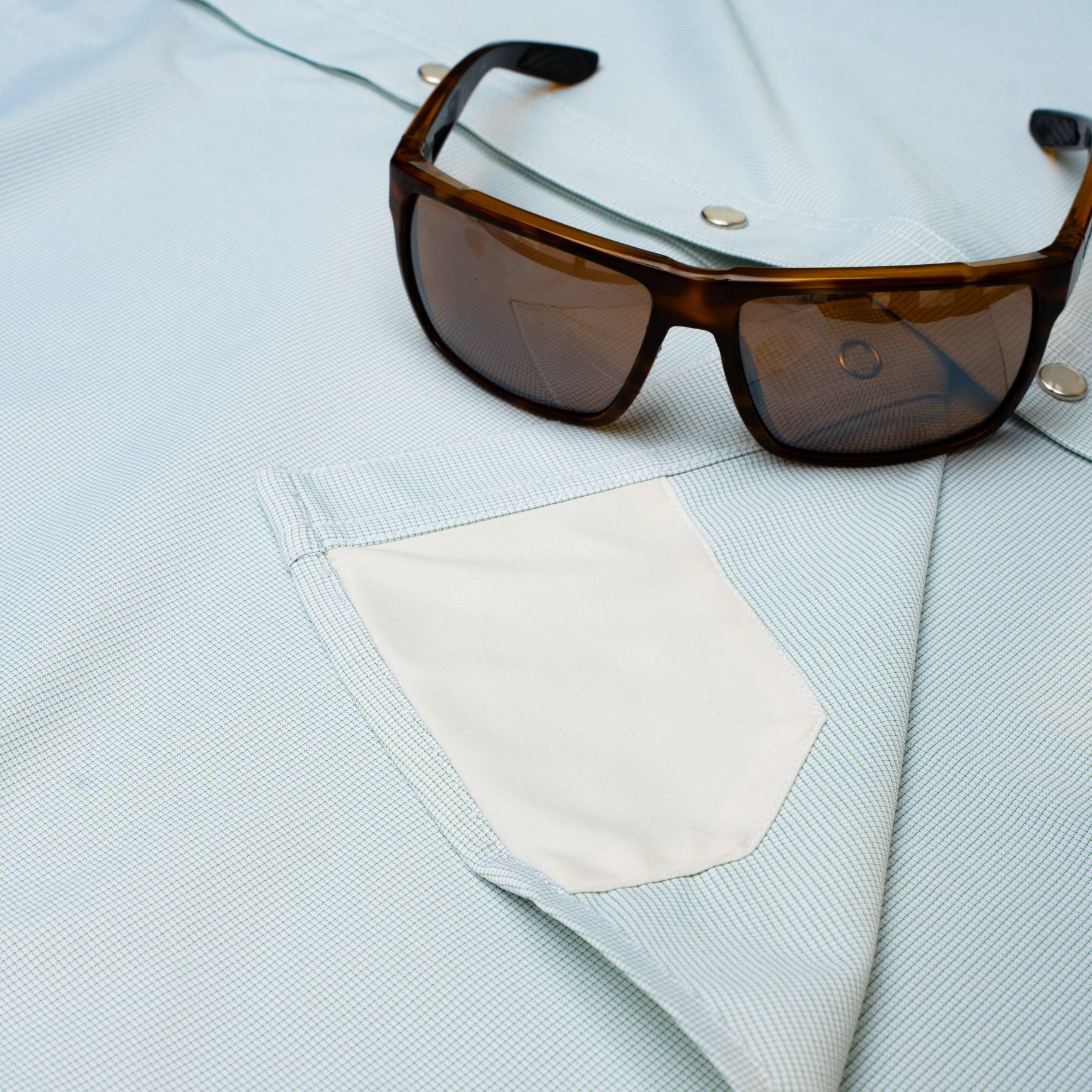 Hidden sunglass cloth on pearl snap shirt 