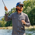 man casting a fly rod on a river in dark grey long sleeve shirt