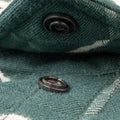 Close up of snap collar on green plaid flannel