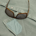 Sunglass cleaner fabric on green denim shirt