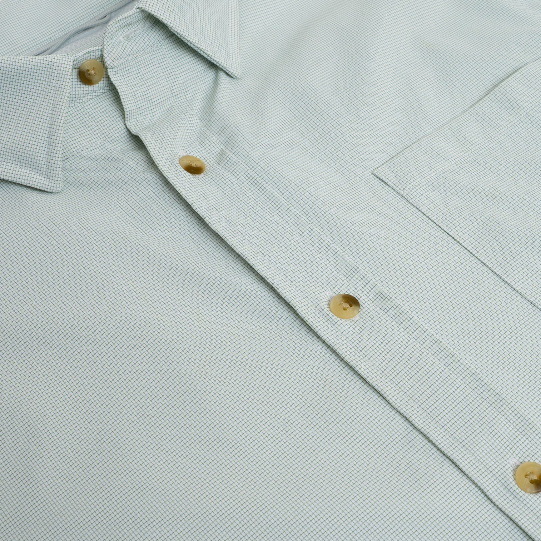 close up of chest pocket on button down green microgrid