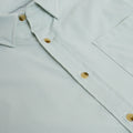 close up of chest pocket on button down green microgrid