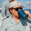 close up photo of man drinking coffee on a boat