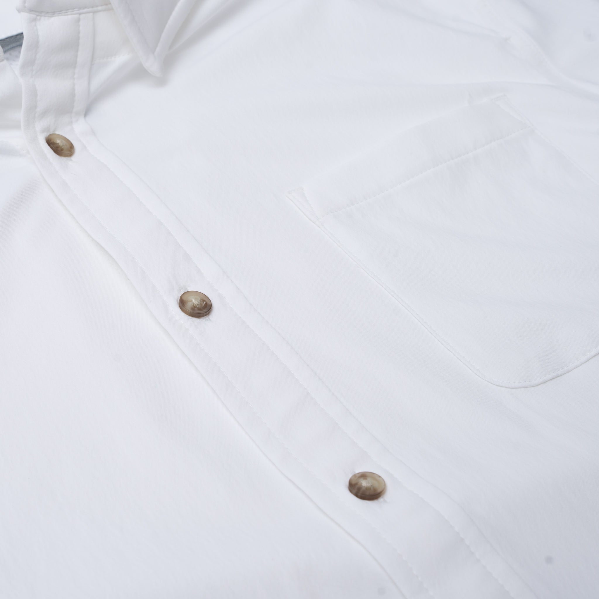 Close up photo of white button down shirt with one pocket