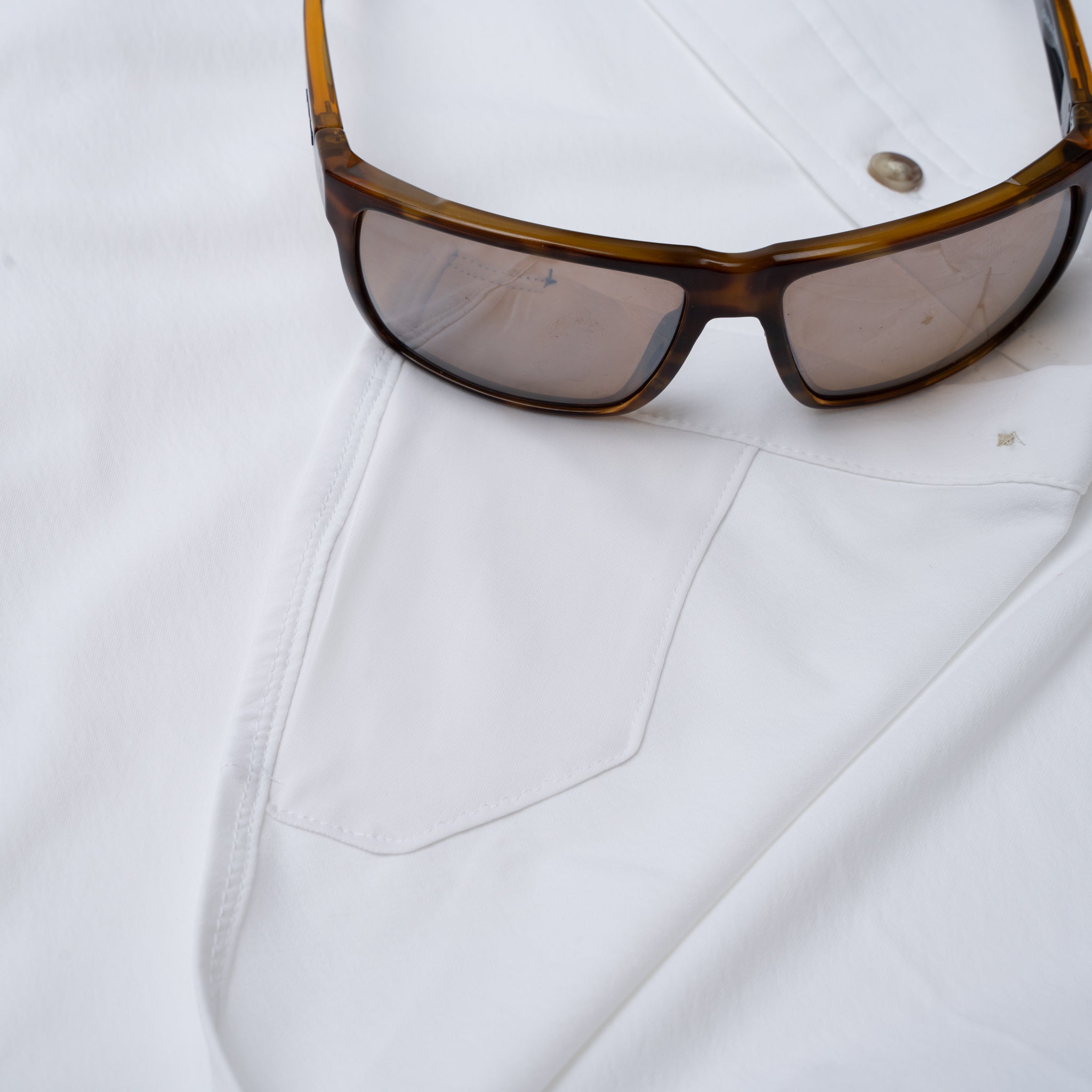 Hidden sunglass cleaner fabric on white button down