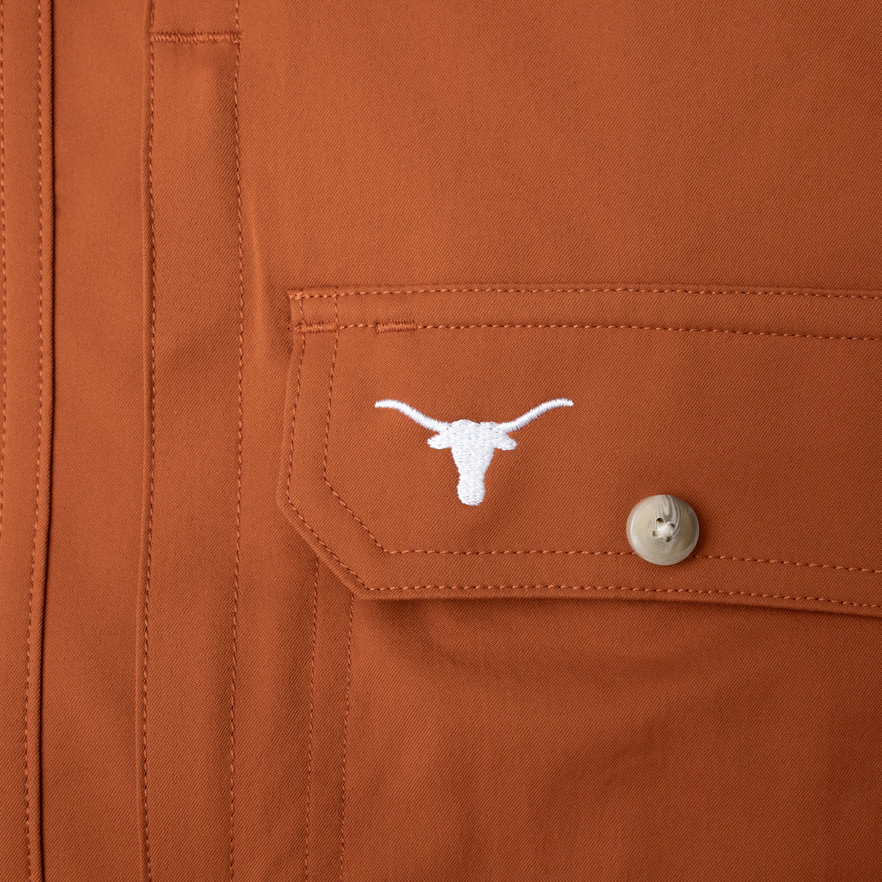 close up of texas longhorn logo on chest pocket