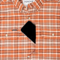 phone in chest pocket of orange plaid flannel shirt