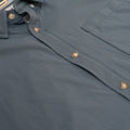 Close up photo of slate blue buttons and chest pocket