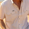 man wearing button up seagull print short sleeve fishing shirt on beach