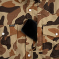 Phone in chest pocket of camo pearl snap flannel shirt