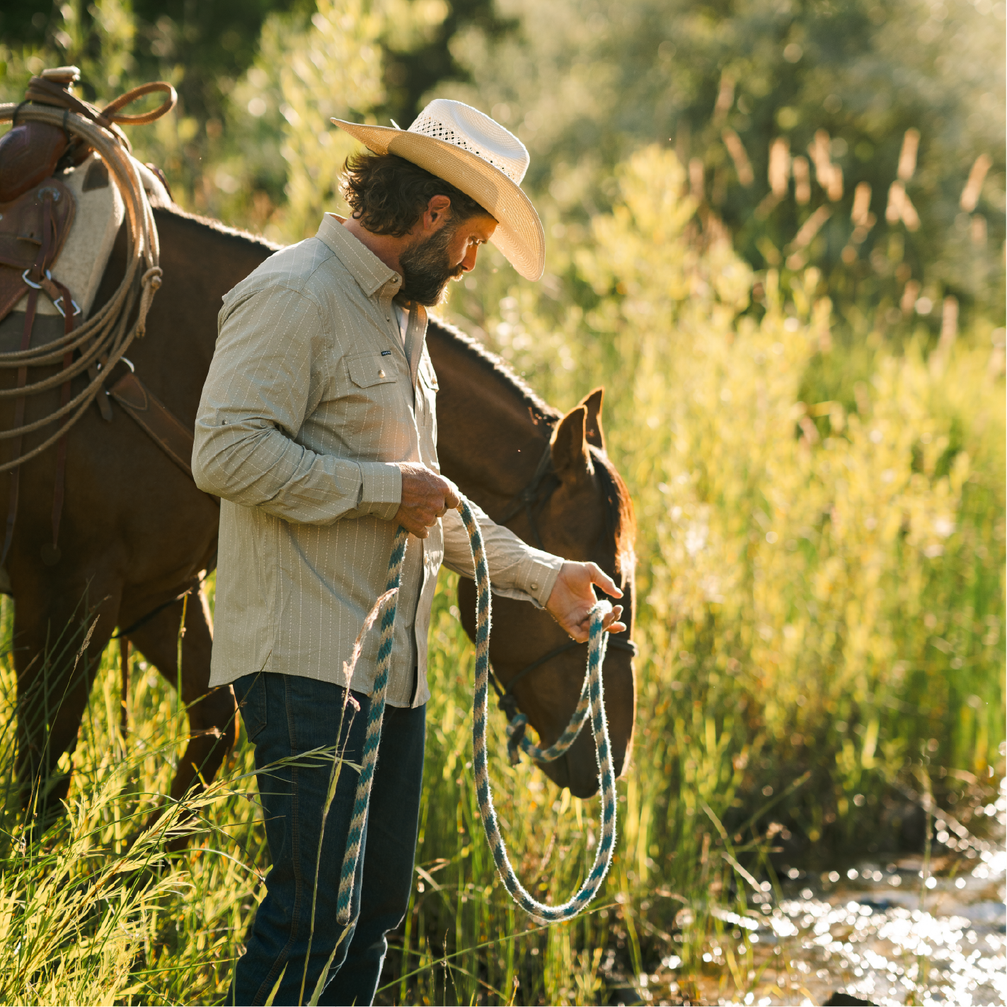 man leading horse to water in green shirt