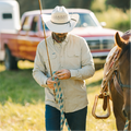 man leading horse out of trailer with fly rod in his hand