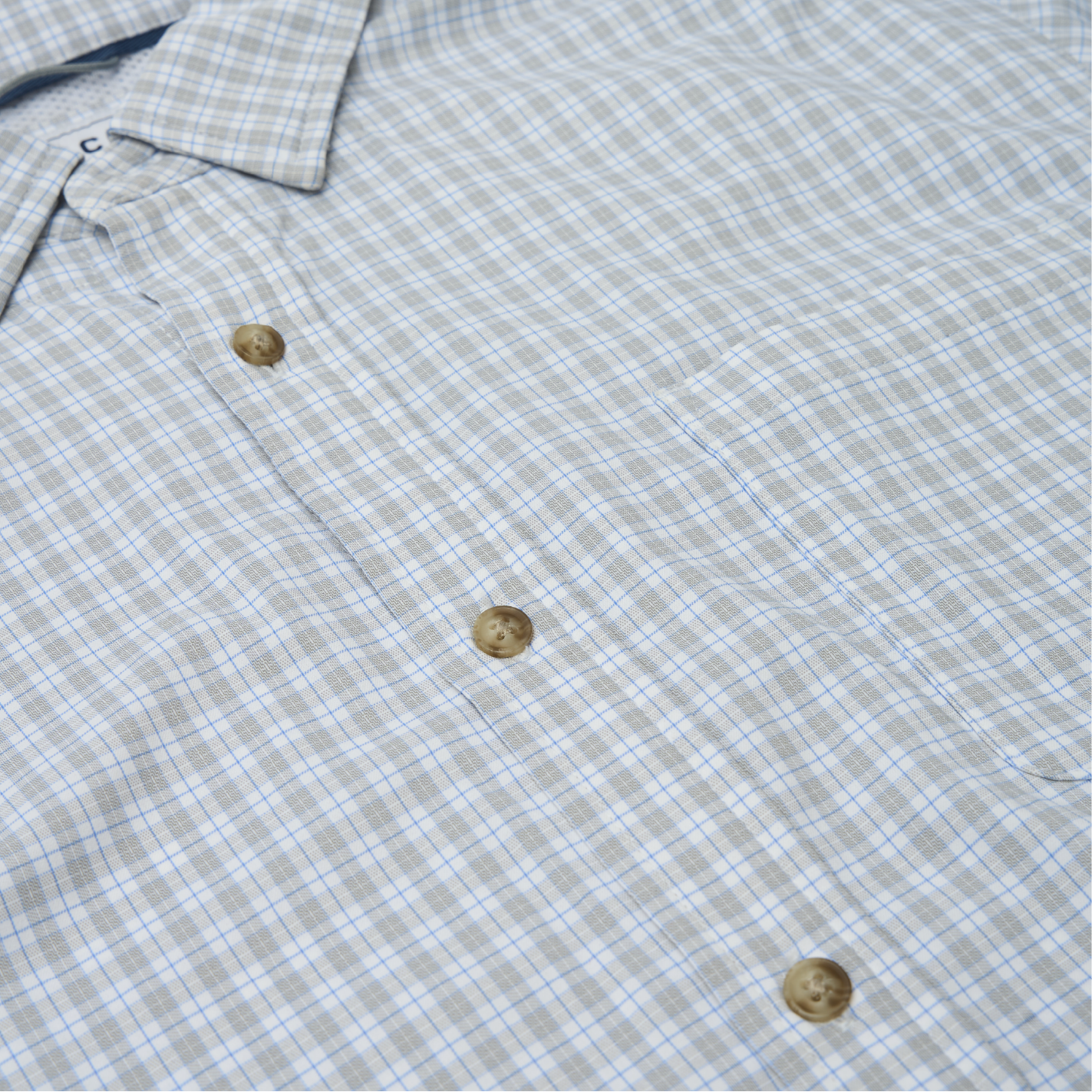 close up photo of blue and grey plaid button down shirt