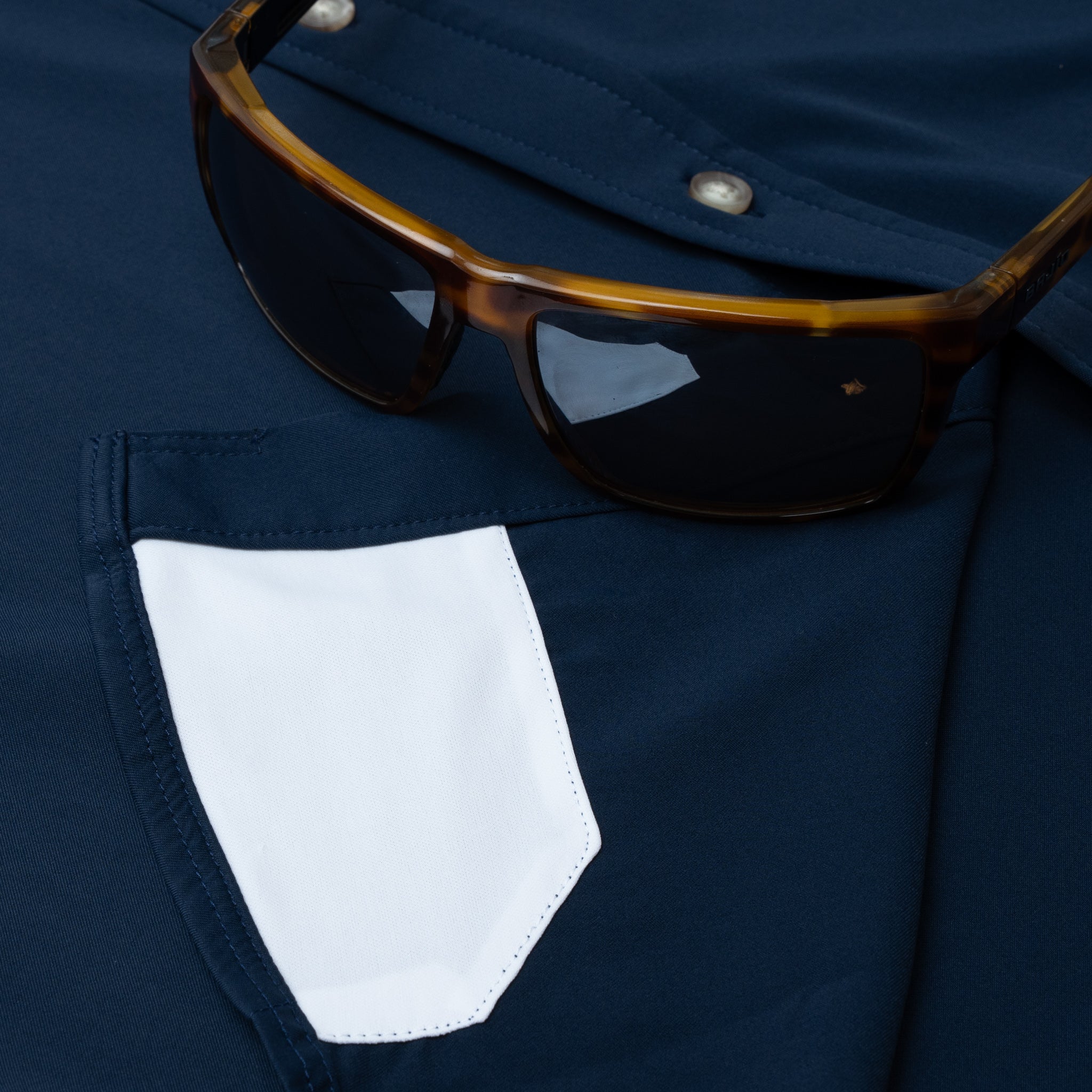 Hidden sunglass cleaner on navy button down shirt