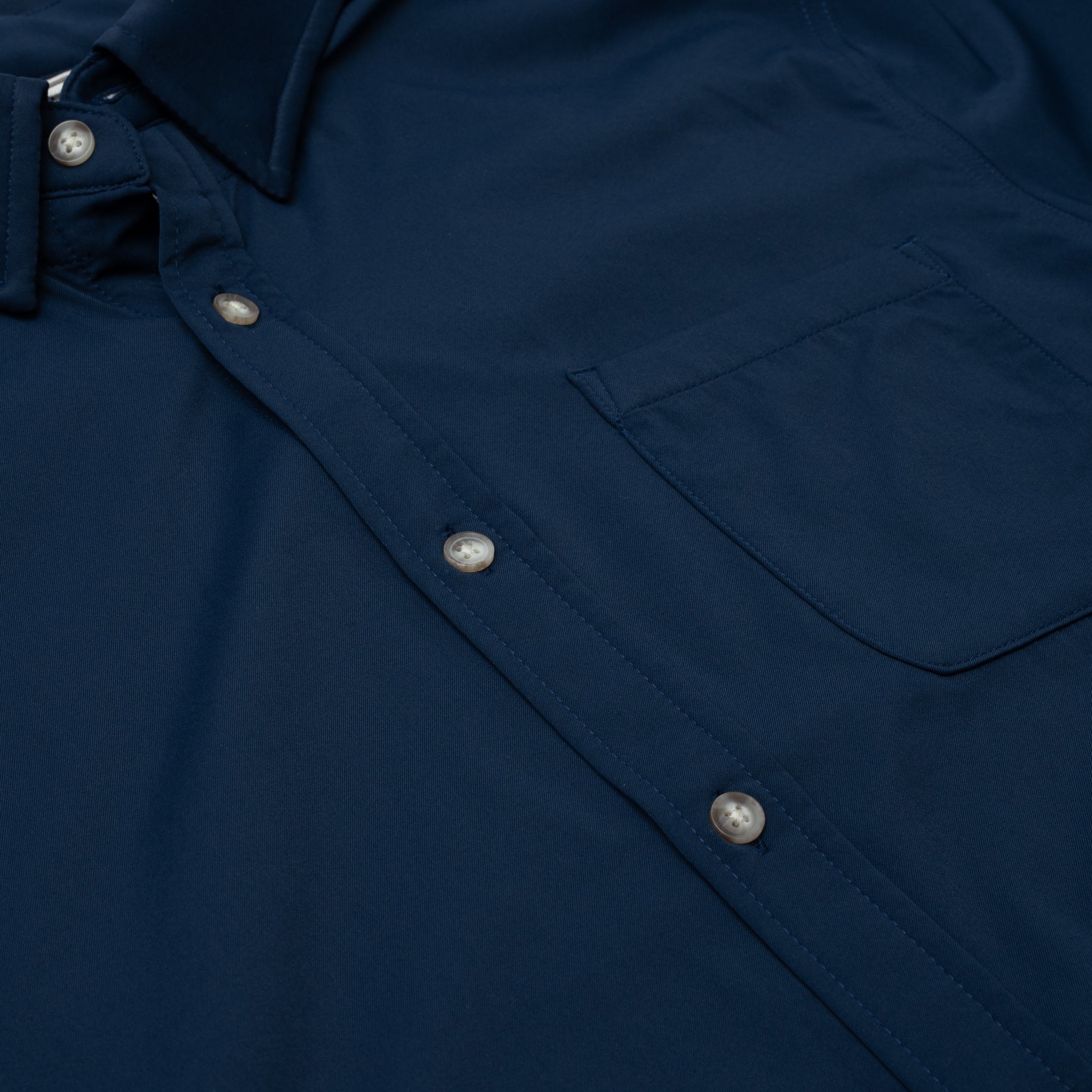 Close up photo of navy button down shirt with one pocket