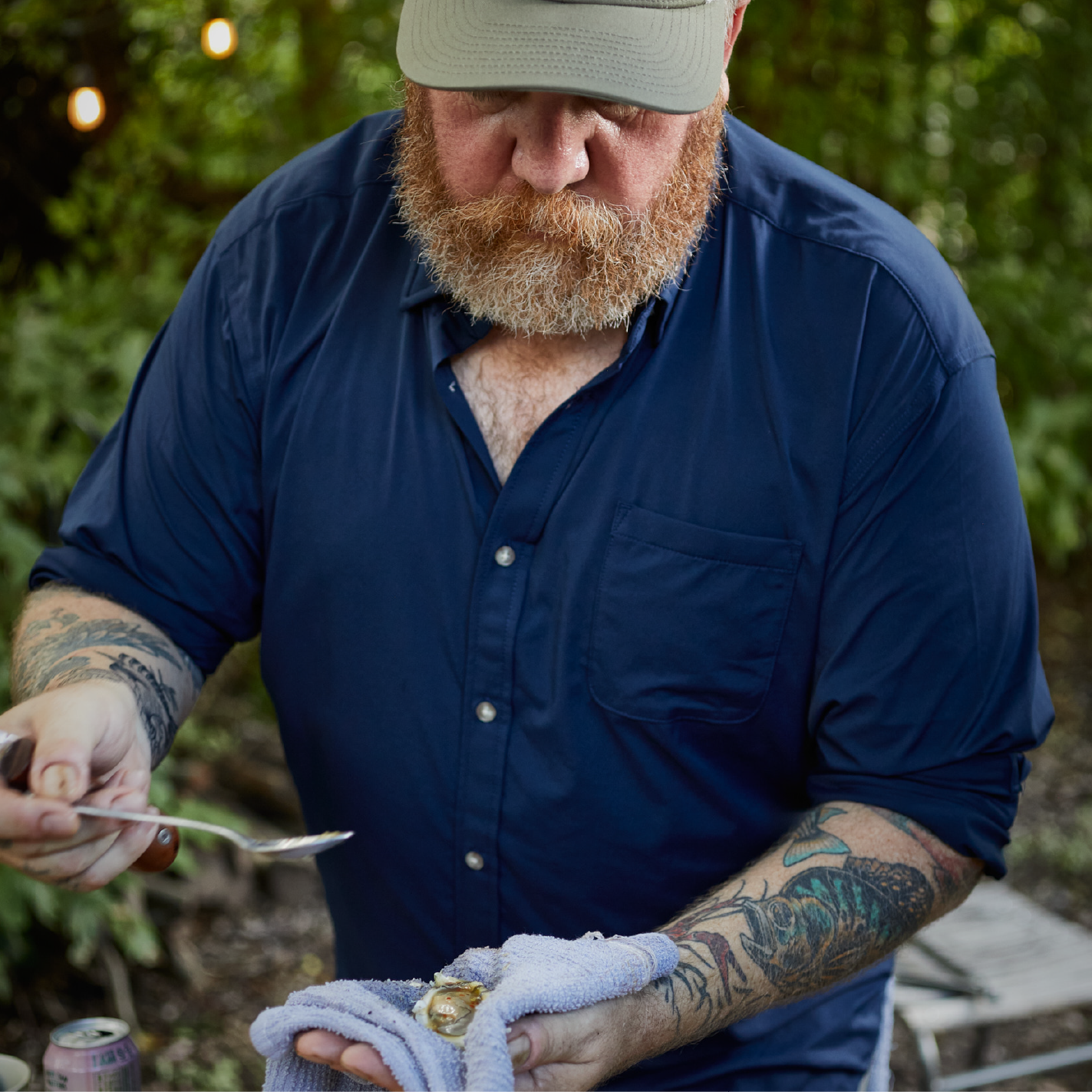 man cooking in navy button down shirt