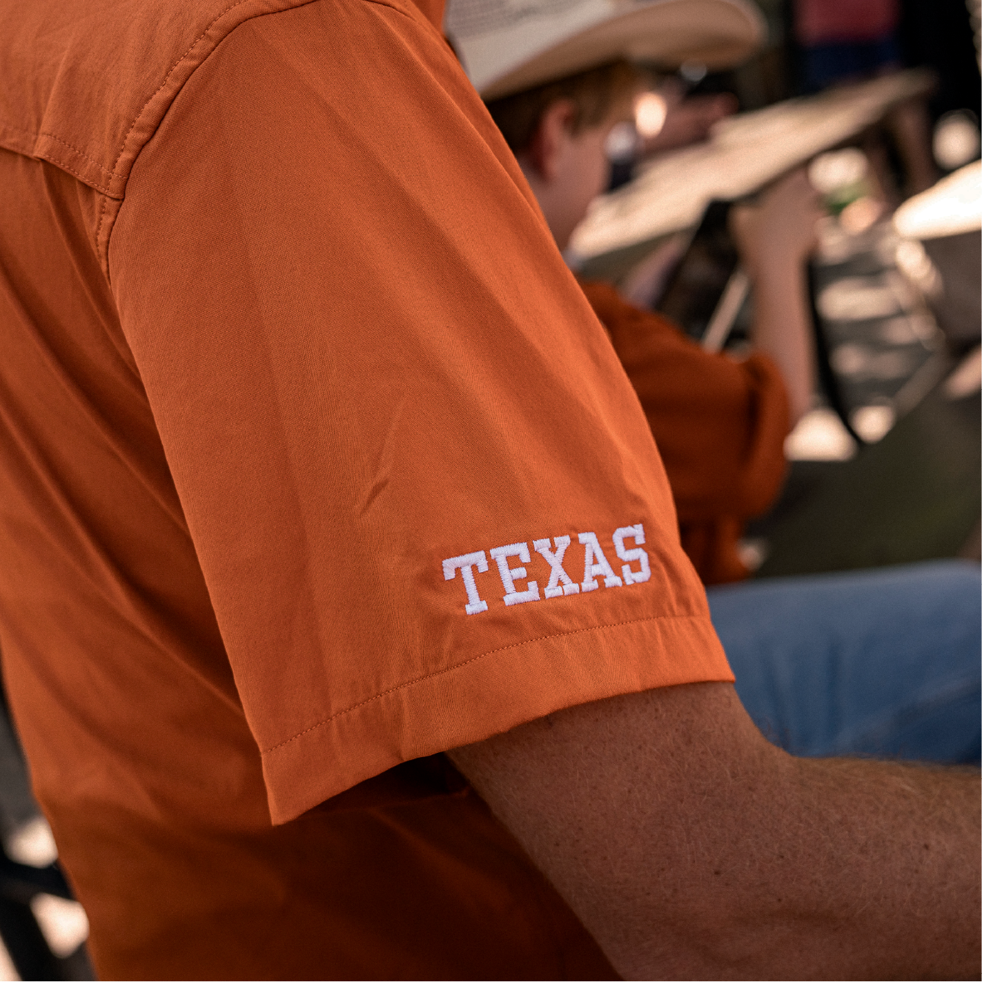 Close up photo of Texas text on sleeve of short sleeve button down