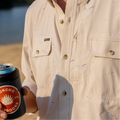 close up photo of seagull fishing shirt with man holding a beer