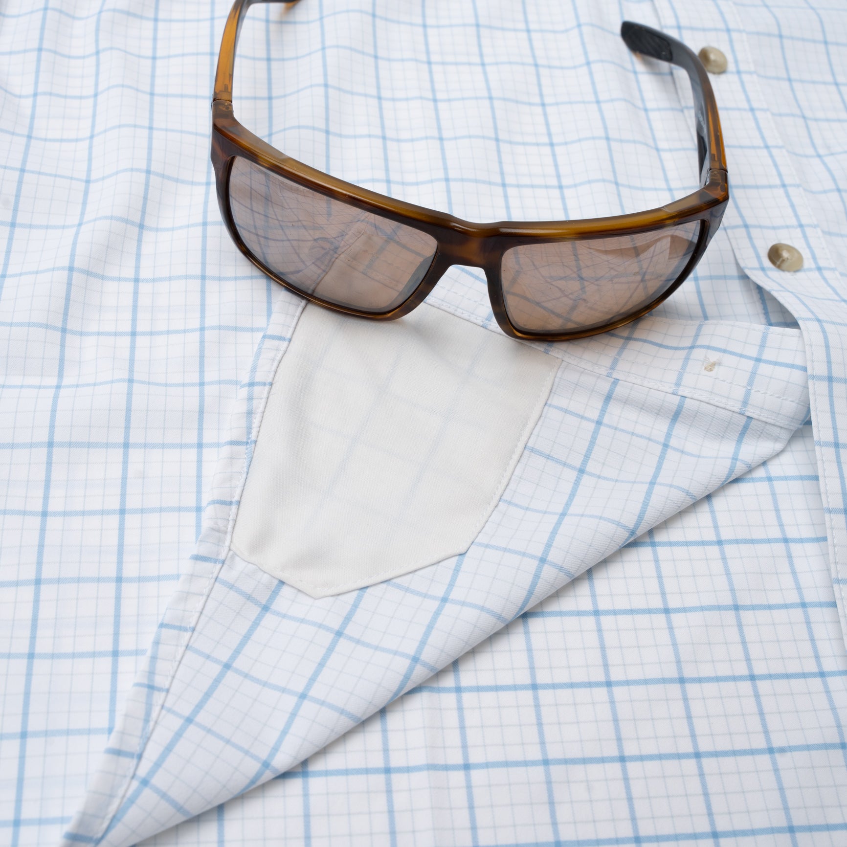 sunglass hidden cleaner on blue plaid button down shirt