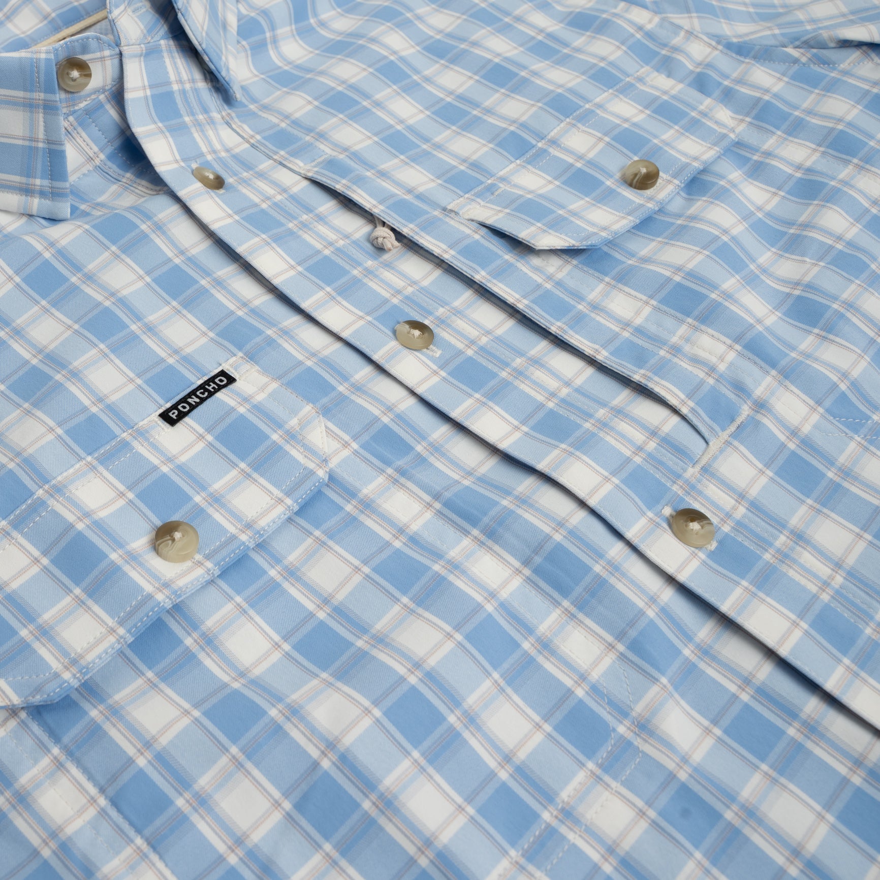 Flat lay photo of a blue plaid shirt