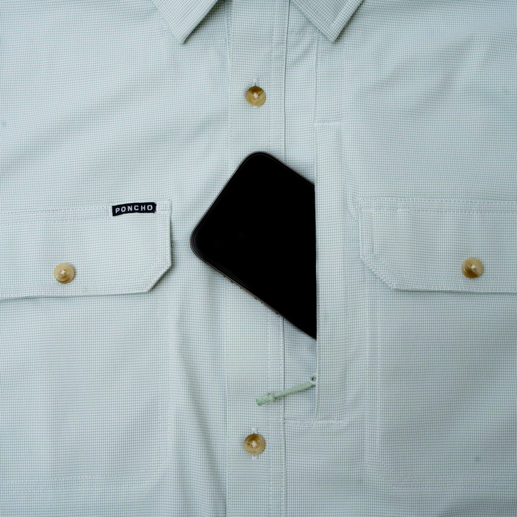 phone in pocket of micro green shirt