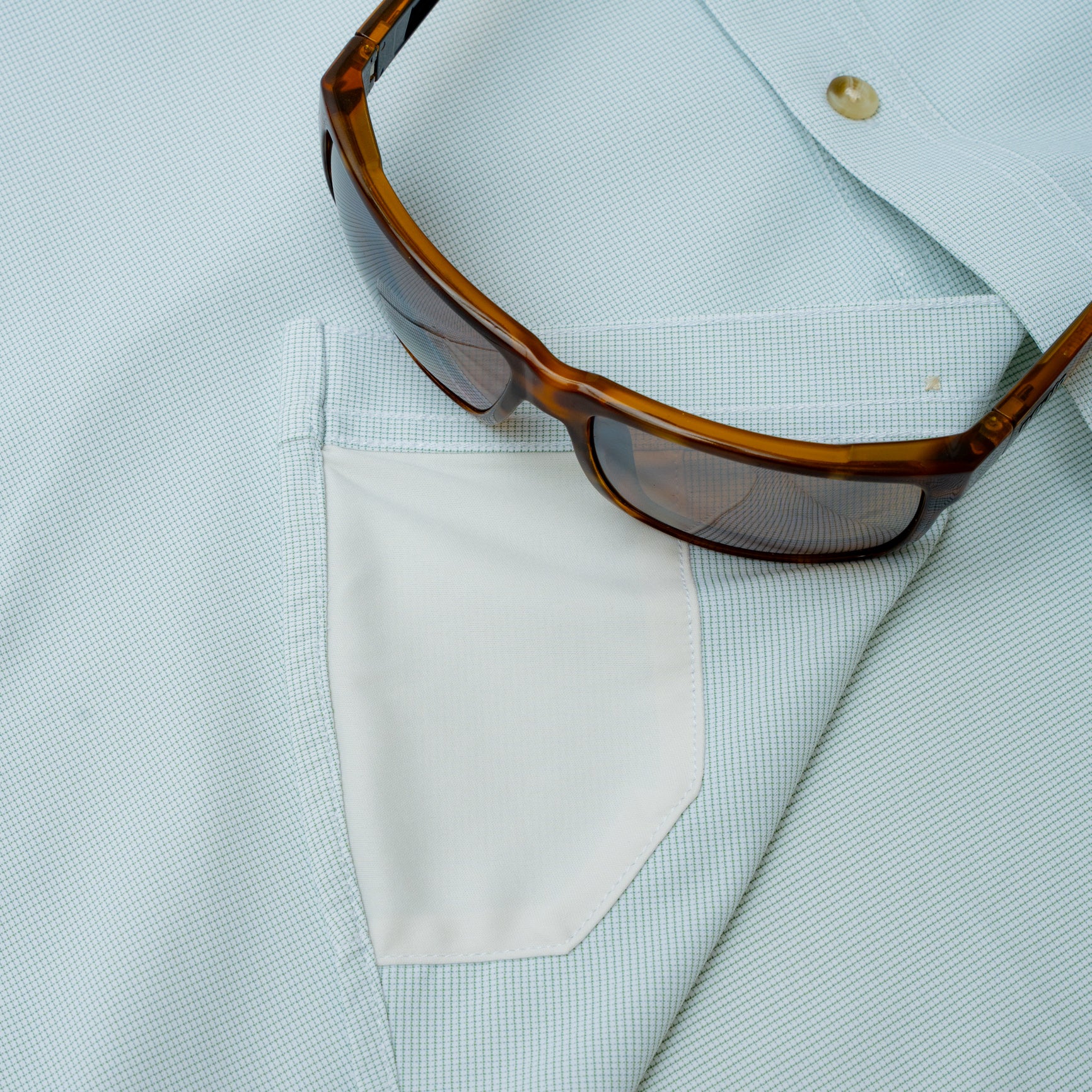 hidden sunglass fabric on micro grid green fishing shirt