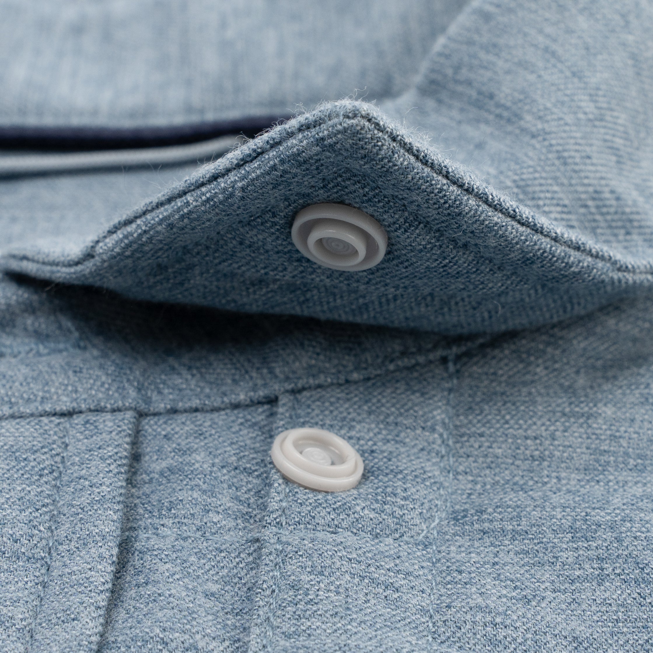 Close up of snap collar on slate blue flannel