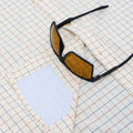 Close up of sunglasses laying on hidden sunglass lens cleaner